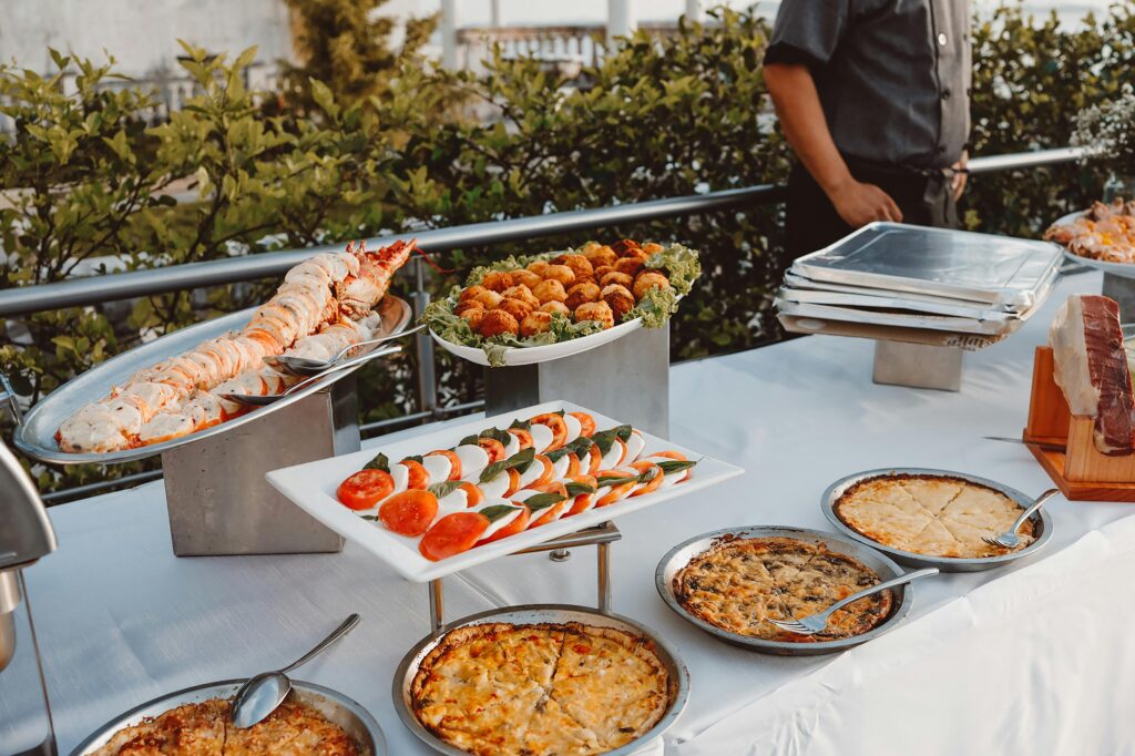 An elegant outdoor buffet set with gourmet dishes, ideal for a sophisticated dinner event.