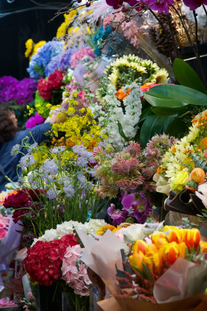 Colorful assortment of flowers at a market stall with diverse floral varieties and vibrant hues.